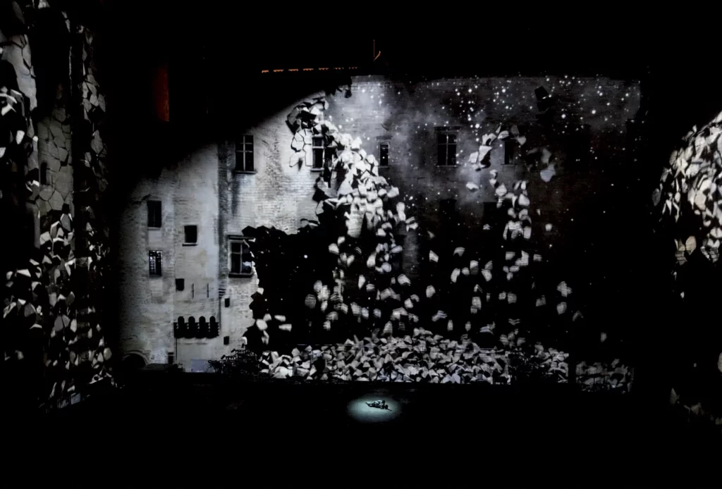 L’effondrement virtuel du Palais à la fin du MAÎTRE ET MARGUERITE de Mikhaïl Boulgakov, mise en scène Simon McBurney / Complicite, dans la Cour d’honneur du Palais des Papes, Festival d’Avignon 2012. Photo Christophe Raynaud de Lage / Festivel d’Avignon.